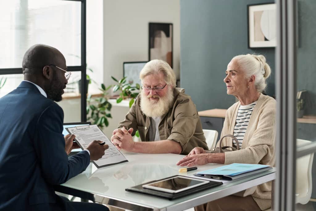 financial manager signing contract with senior couple