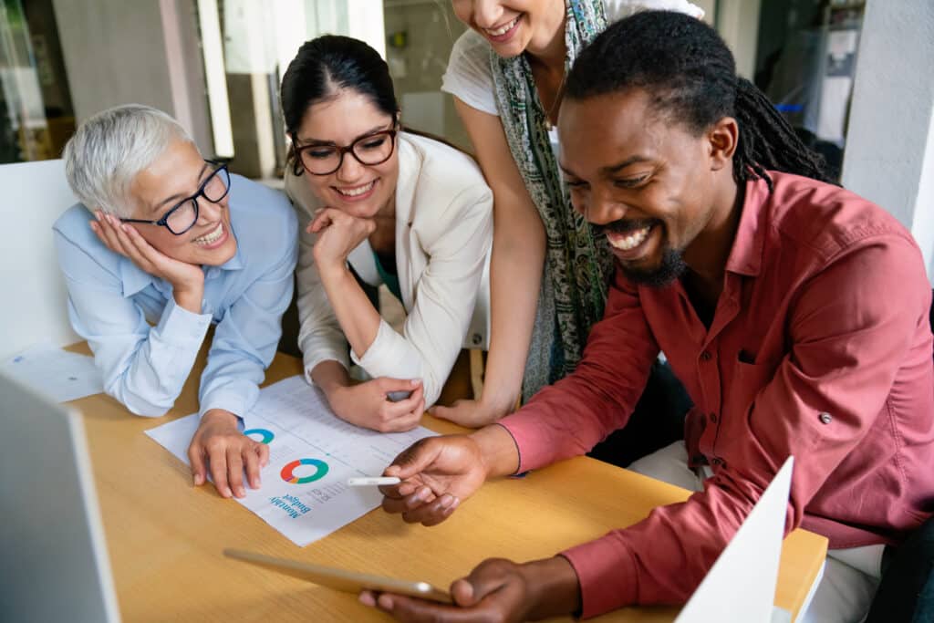 group of business partners discussing documents and ideas at meeting in corporate office