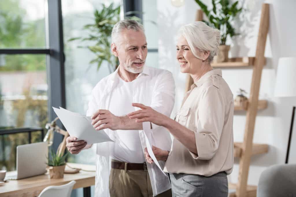 senior business colleagues converse at office